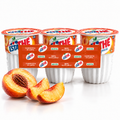 Estathé pêche — pack de 3 × 200 ml, mise en scène avec des pêches